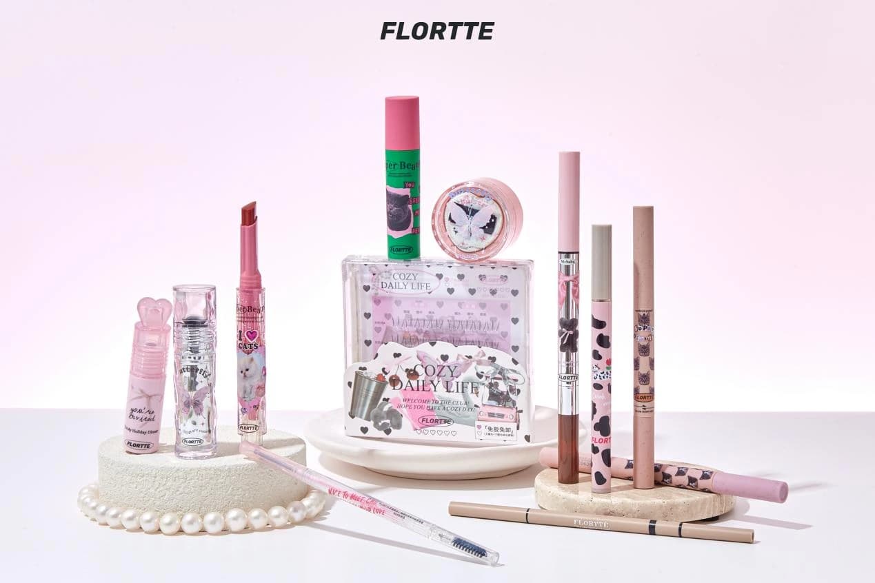 FLORTTE makeup products on a pink display